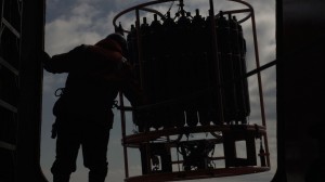 Oceanographic instrument is lowered to collect water samples at different ocean depths